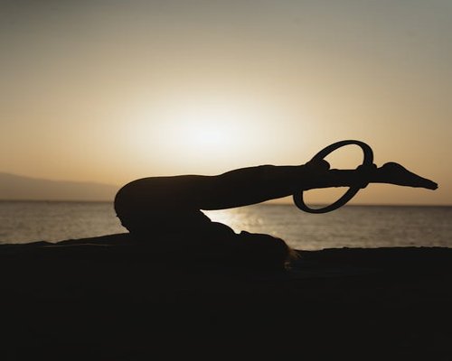 Woman doing light stretching yoga near window in morning